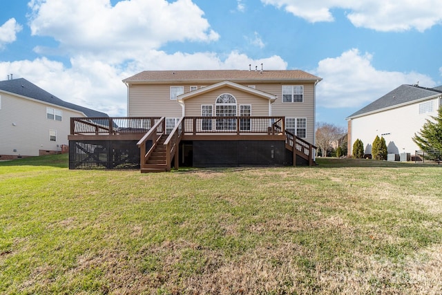 rear view of house featuring a lawn and a wooden deck