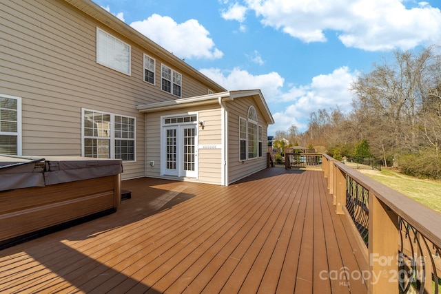 wooden terrace with a hot tub