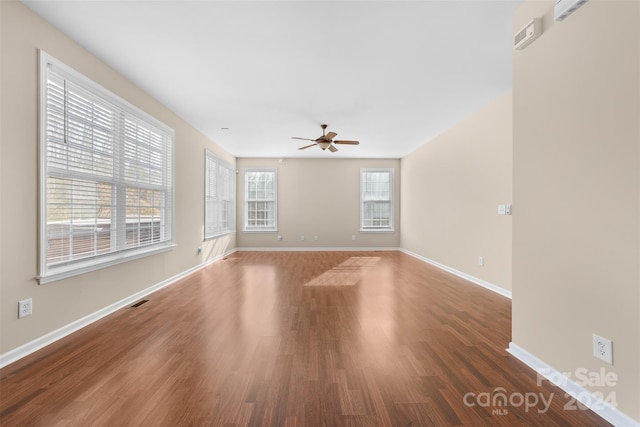 empty room featuring ceiling fan and dark hardwood / wood-style floors