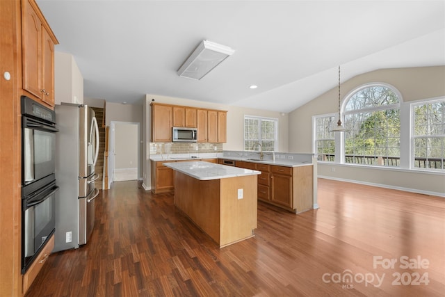 kitchen featuring decorative backsplash, dark hardwood / wood-style flooring, vaulted ceiling, black appliances, and a kitchen island