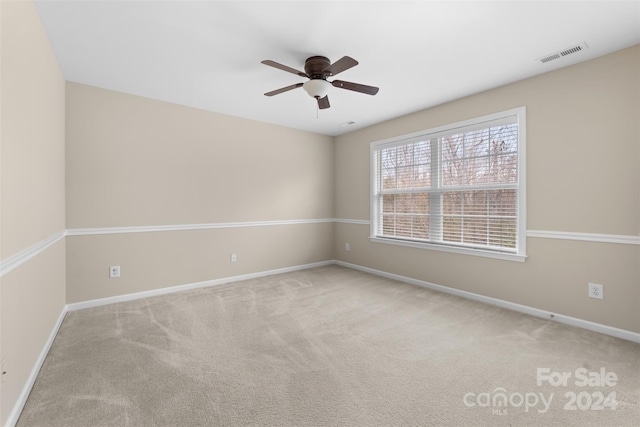 unfurnished room with ceiling fan and light colored carpet