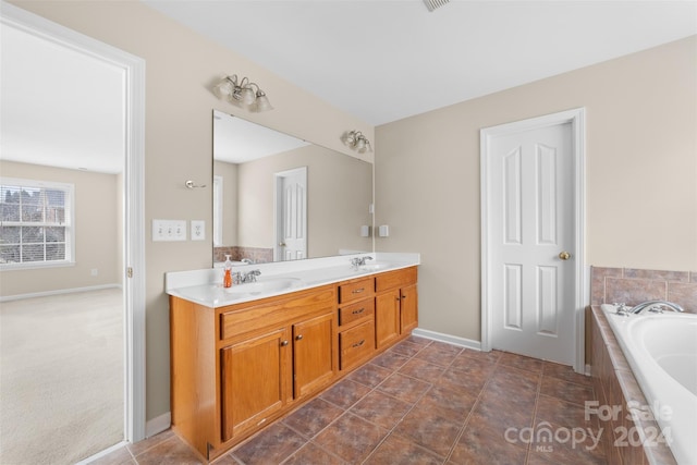 bathroom with vanity and a relaxing tiled tub