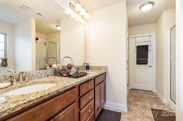 bathroom featuring vanity and a shower with shower door