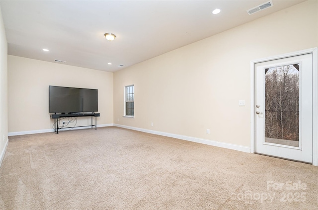 unfurnished living room featuring light colored carpet