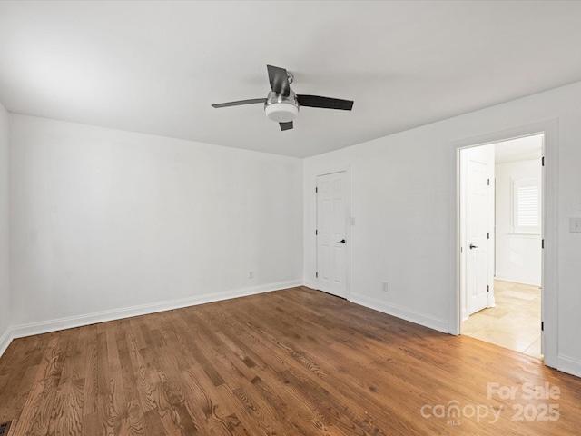 empty room featuring hardwood / wood-style floors and ceiling fan