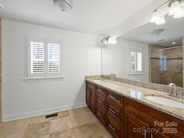 bathroom featuring vanity and a shower with shower door