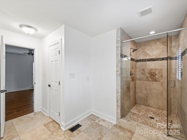 bathroom with ceiling fan and a shower with shower door