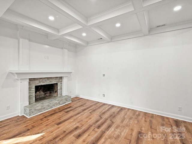 unfurnished living room with beam ceiling, a fireplace, and coffered ceiling