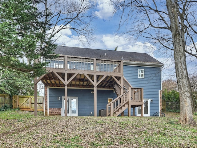 rear view of property featuring a wooden deck