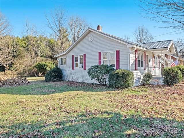 view of side of property with a yard and a porch