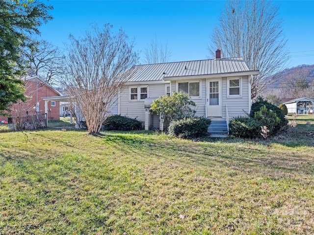 back of property featuring a lawn