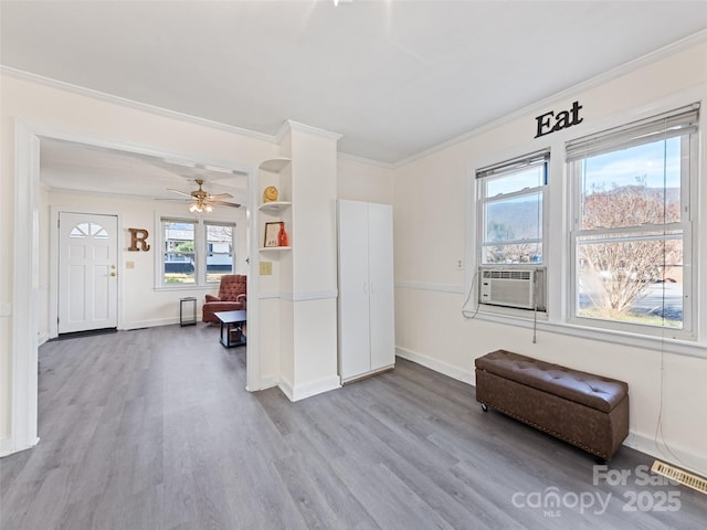 interior space featuring ceiling fan, hardwood / wood-style floors, cooling unit, and ornamental molding