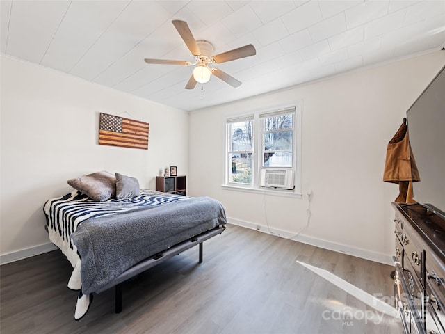 bedroom featuring hardwood / wood-style flooring, ceiling fan, and cooling unit