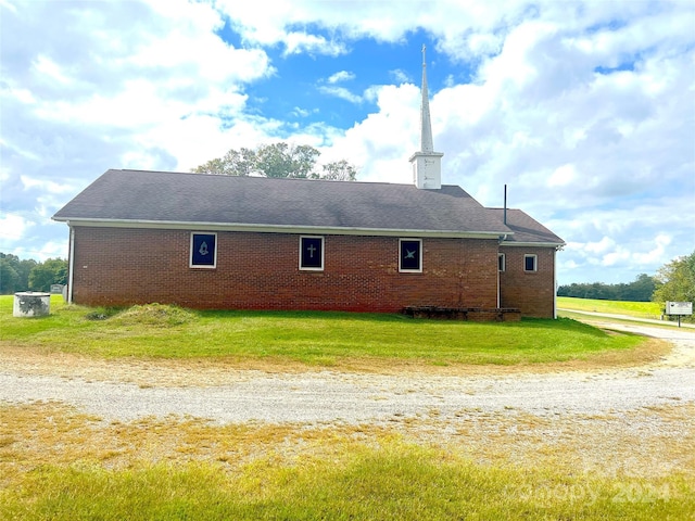 view of side of home with a yard