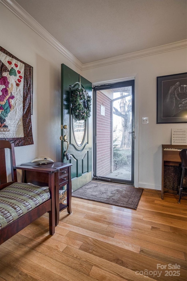 foyer featuring hardwood / wood-style flooring and crown molding