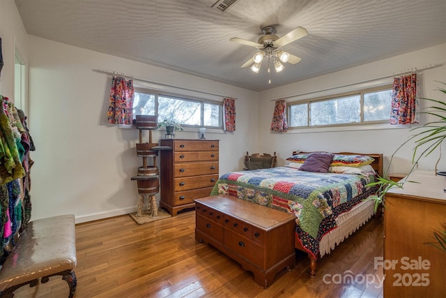 bedroom with ceiling fan and hardwood / wood-style flooring