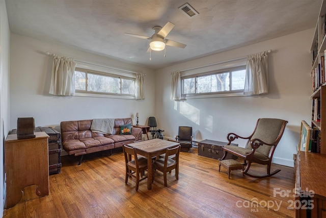 living room with hardwood / wood-style flooring and ceiling fan