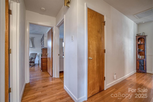 hallway with light hardwood / wood-style flooring