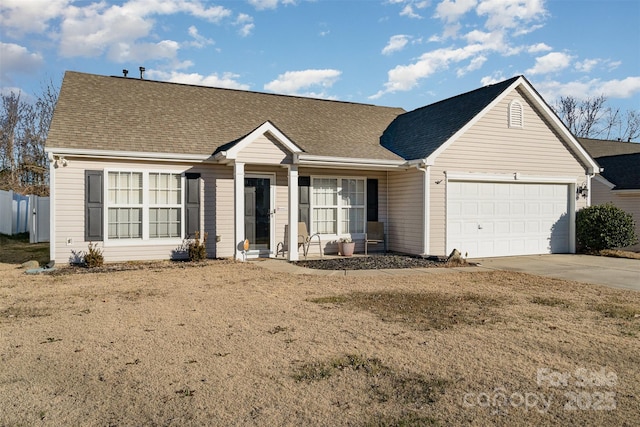 ranch-style house featuring a front lawn and a garage