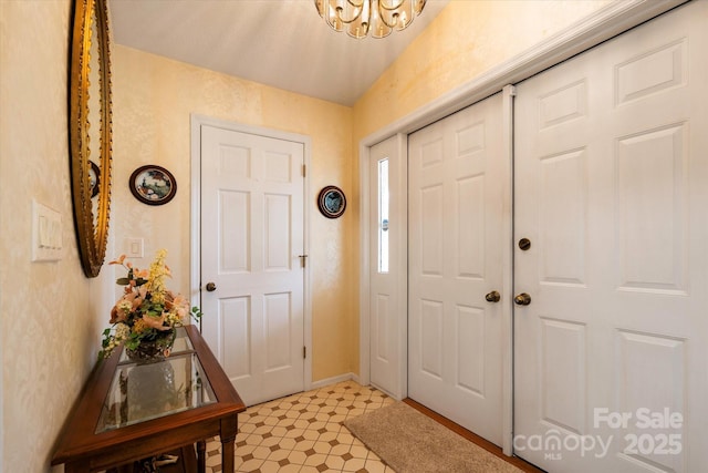 entryway with a chandelier