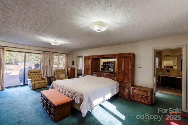 bedroom with access to exterior, a textured ceiling, dark carpet, and connected bathroom