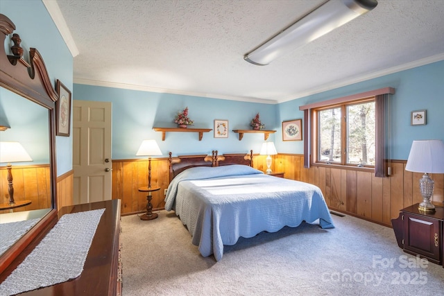 carpeted bedroom featuring a textured ceiling and crown molding