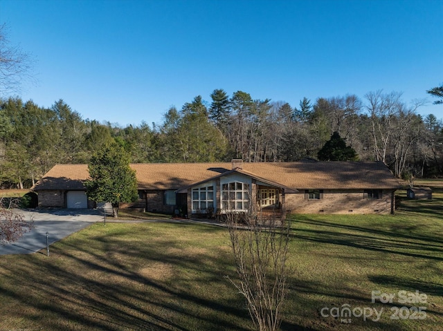 single story home with a front lawn and a garage