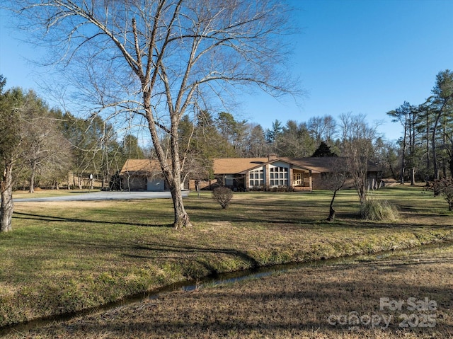 ranch-style house with a front yard and driveway