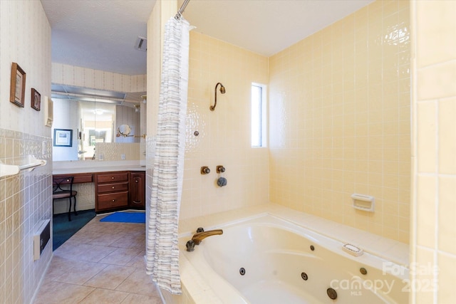 full bathroom with plenty of natural light, vanity, tile walls, and tile patterned flooring