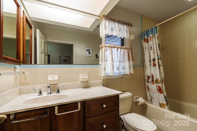 full bath featuring shower / tub combo, vanity, tile walls, and toilet