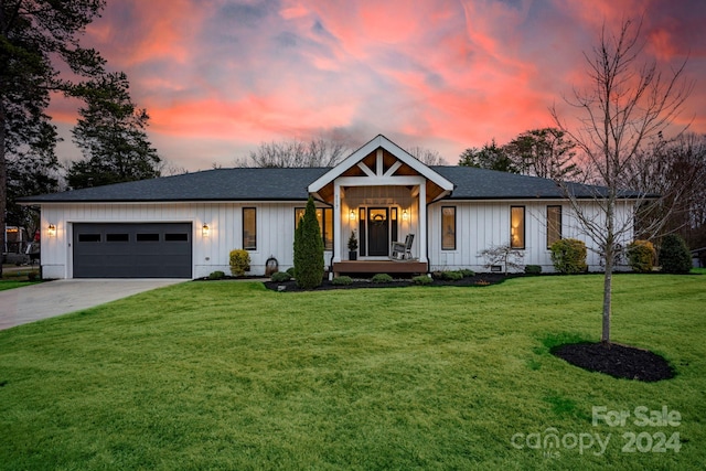 view of front of property with a yard and a garage