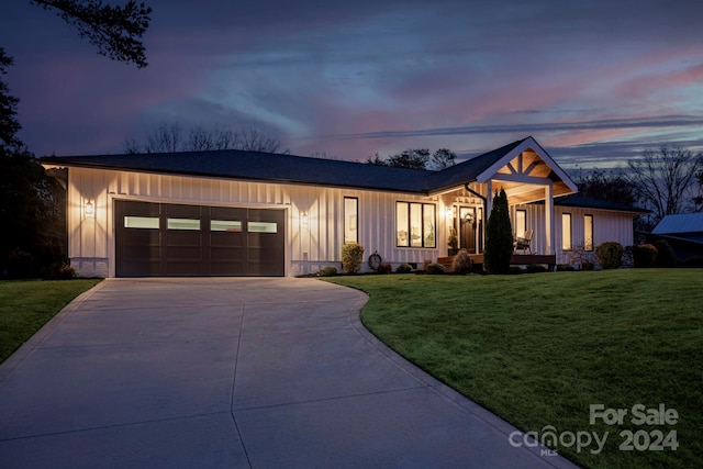 view of front facade with a lawn and a garage