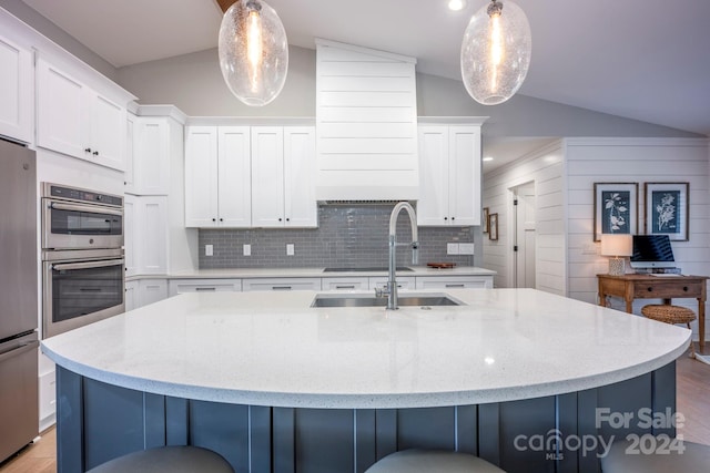 kitchen with decorative light fixtures and vaulted ceiling