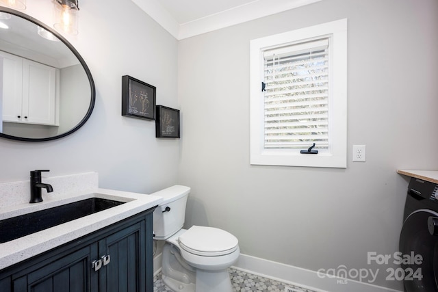 bathroom with vanity, toilet, washer / dryer, and ornamental molding