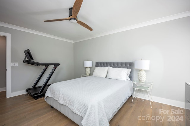 bedroom featuring hardwood / wood-style floors, ceiling fan, and ornamental molding