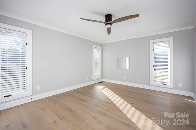 spare room featuring wood-type flooring, ceiling fan, and ornamental molding