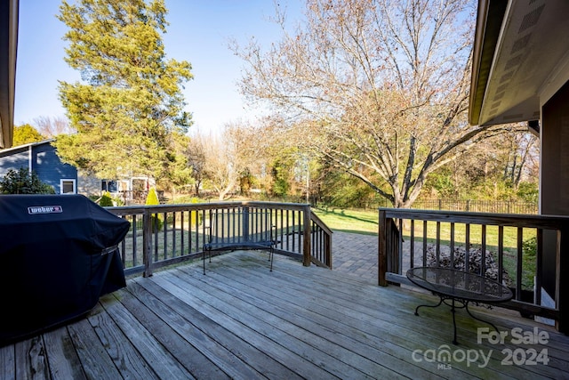 wooden deck with a grill