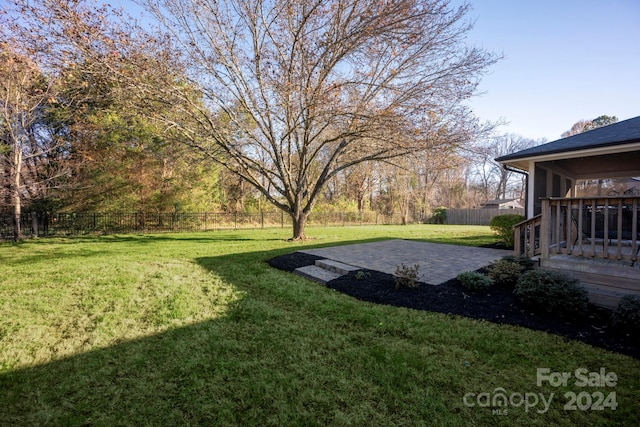 view of yard with a sunroom and a patio