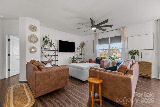 living room featuring dark hardwood / wood-style flooring and ceiling fan