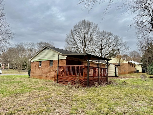 view of home's exterior featuring a lawn and a wooden deck