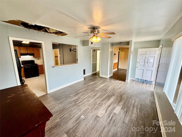 unfurnished living room with hardwood / wood-style flooring and ceiling fan