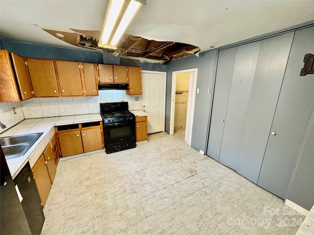 kitchen featuring sink and black appliances