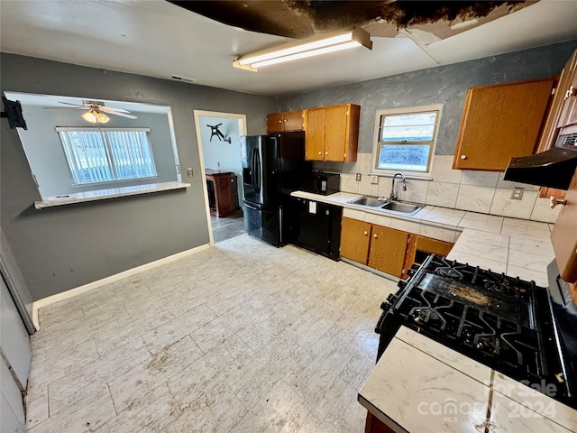 kitchen with backsplash, ceiling fan, sink, and plenty of natural light