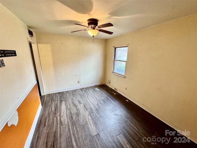 unfurnished bedroom featuring ceiling fan and dark wood-type flooring