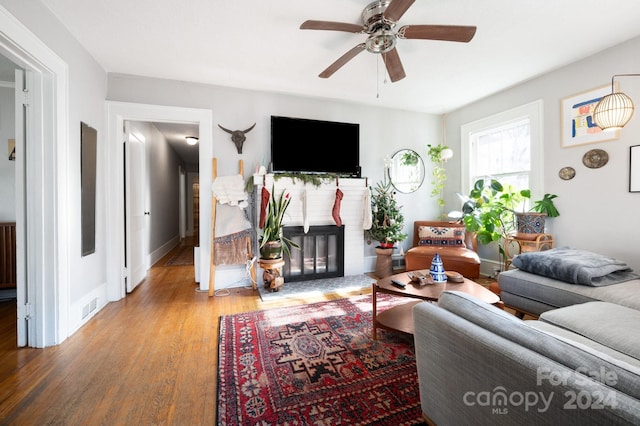 living room with ceiling fan and hardwood / wood-style flooring