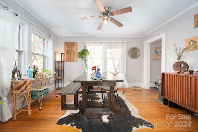 dining space featuring ceiling fan, ornamental molding, and hardwood / wood-style flooring