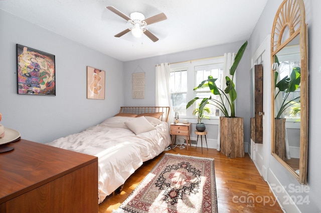 bedroom with ceiling fan and light hardwood / wood-style floors