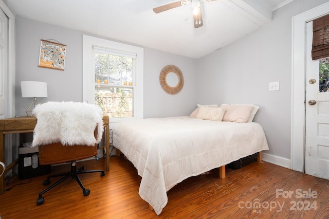 bedroom featuring hardwood / wood-style flooring, ceiling fan, and vaulted ceiling