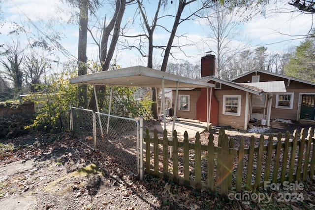 rear view of property featuring a carport