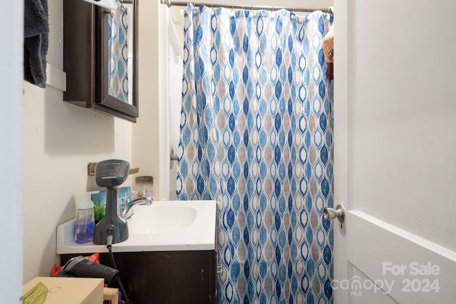 bathroom featuring vanity and curtained shower